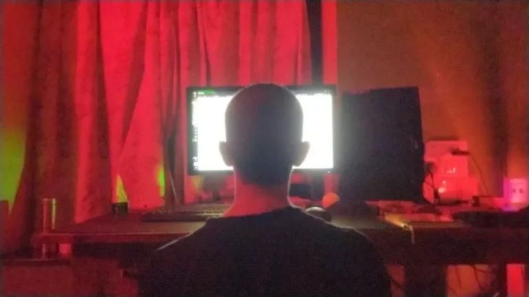 guy in front of screen in red room